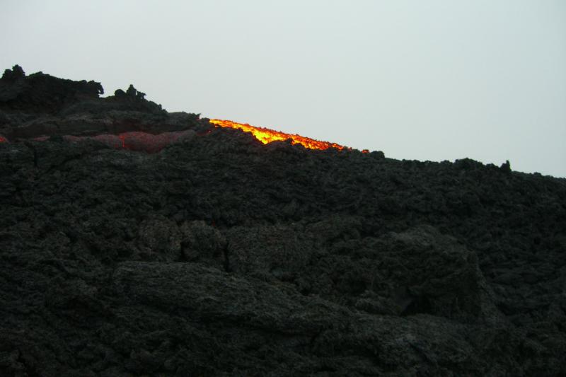 Volcan Pacaya-r.JPG - At the top, lava is flowing out of the volcano, down the side of the hill, under all of the rocks that act as a bridge to area of the major flow. Walking on this hot and fragile rock was perhaps the most frightening thing we had ever done.